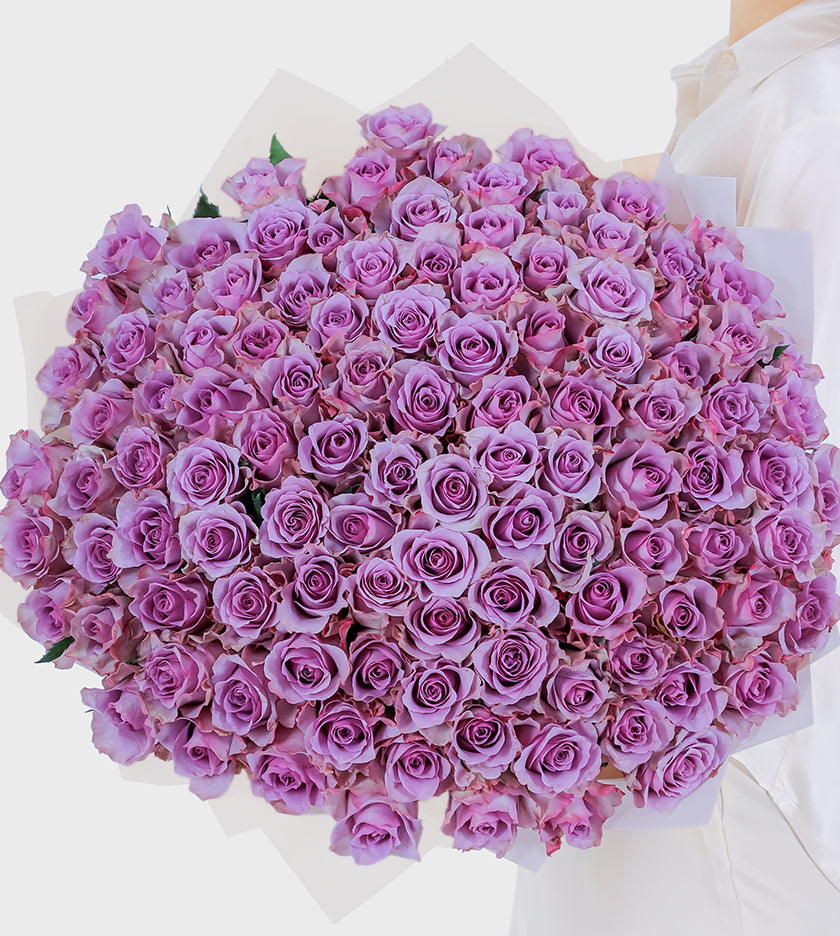Embrace luxury with our 100 purple blooms of elegance, mystery, and admiration. A lavish statement for any occasion.