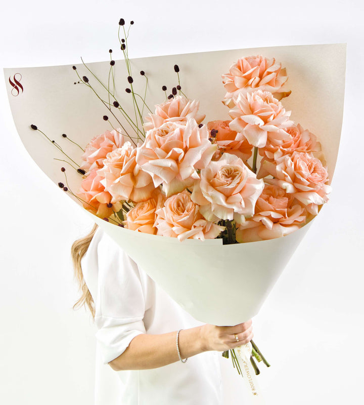 Bouquet of fiery orange roses with crimson-edged petals.
