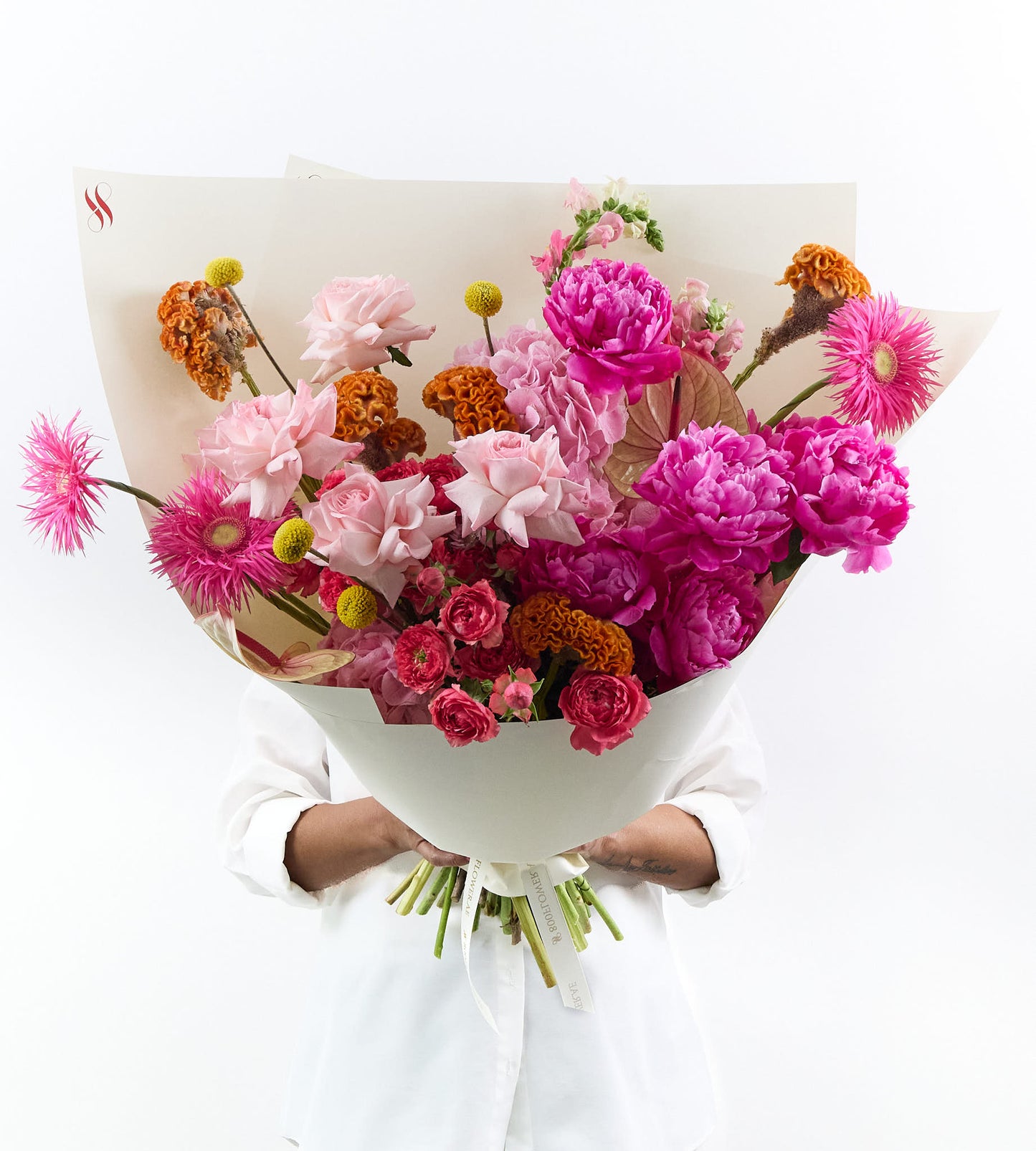 Colorful bouquet with pink, orange, and golden flowers, bright and joyful.