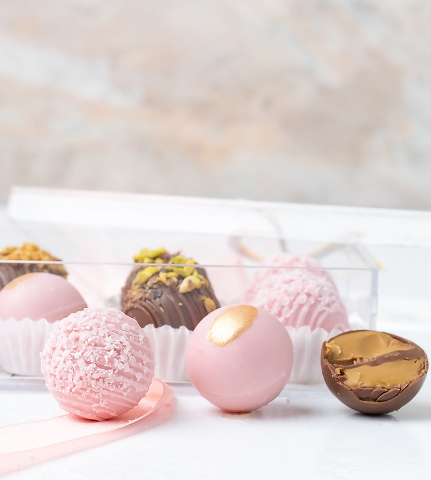 Gift box with 10 assorted truffles filled with peanut butter, pistachio, almond, and lotus flavors – tray size 20 by 8 cm
