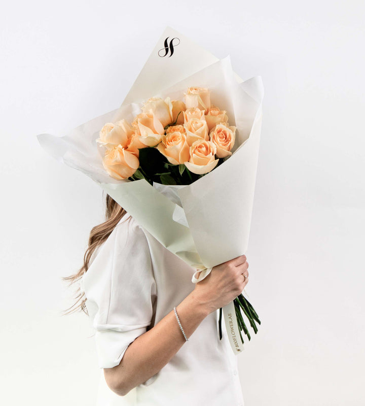 Soft peach rose bouquet with fresh petals, perfect for weddings and gifts.