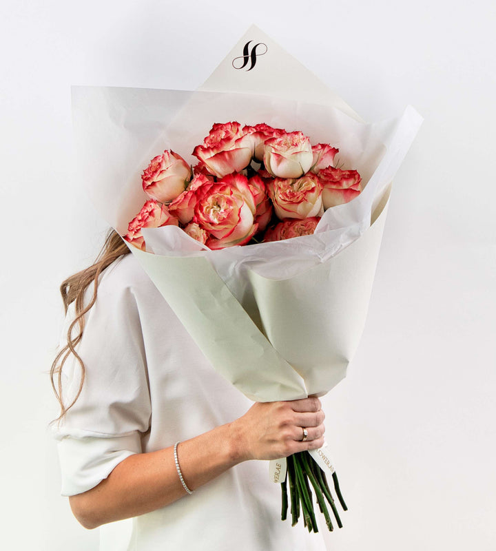 Bouquet of creamy blush and vibrant pink roses, romantic and bold.