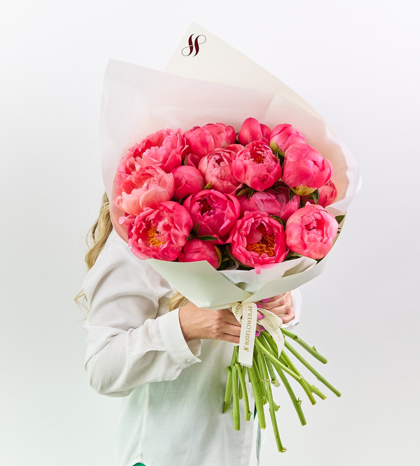 Coral-peach peonies bouquet with soft petals glowing like a sunset.