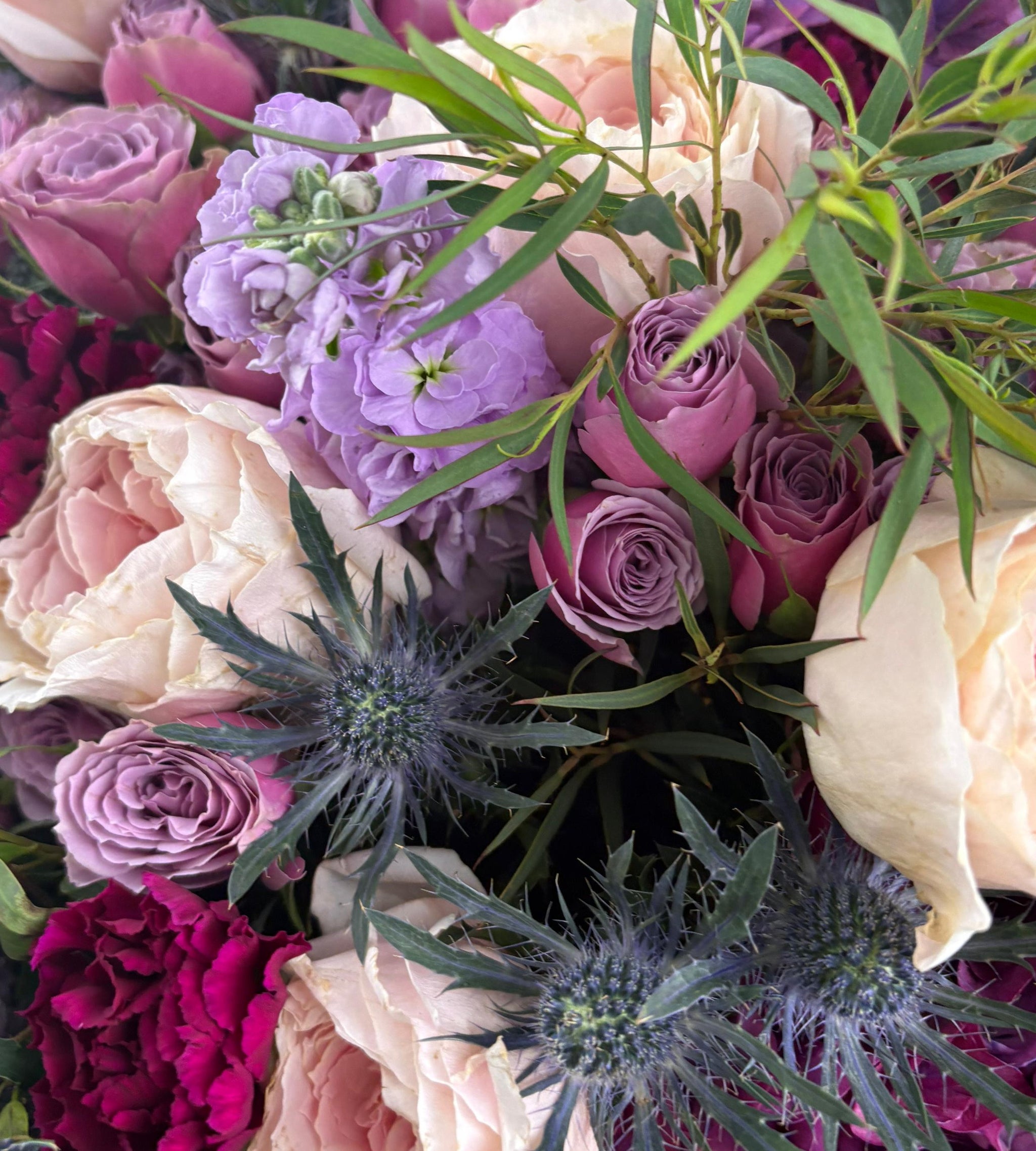 A dreamy mix of blush, violet, and wine-toned blooms with soft greens woven through. Twilight Muse captures the mood of a slow sunset and the beauty that lingers after.