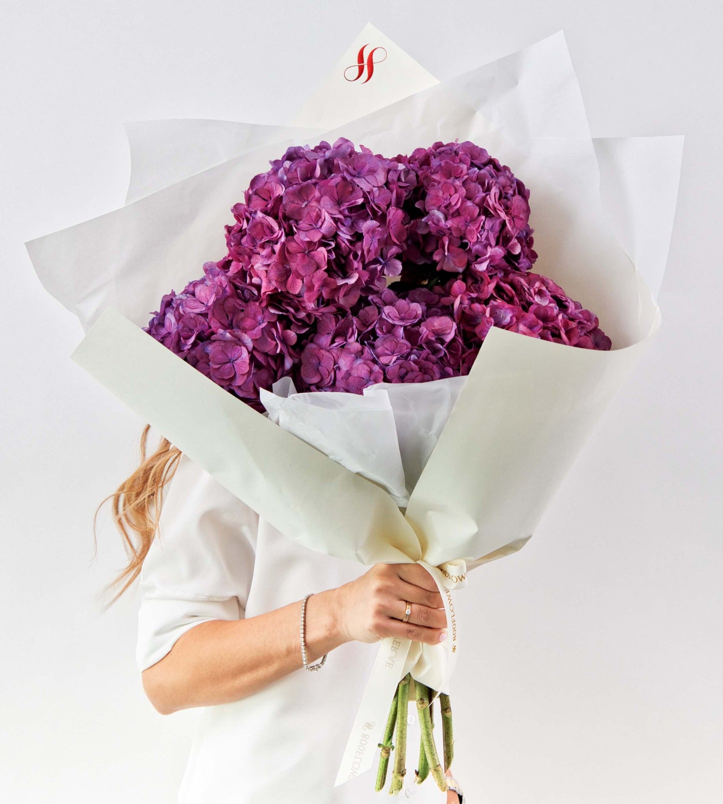 Lush deep purple hydrangea bouquet with rich texture and bold color.