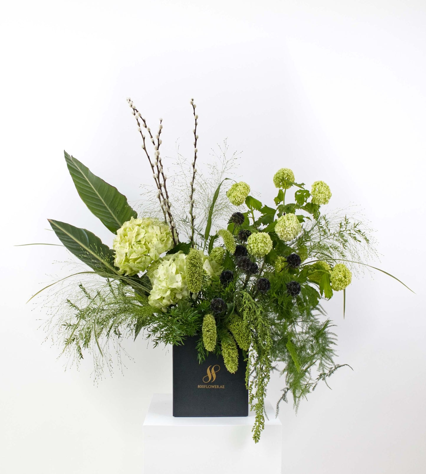 Bouquet with textured green foliage and earthy tones.