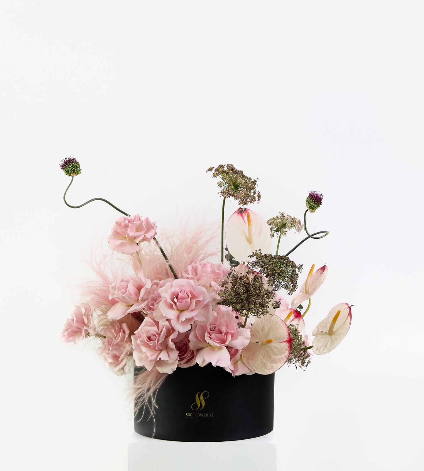 Wild Rosé bouquet with soft pink roses, sculptural anthuriums, and feathery textures.