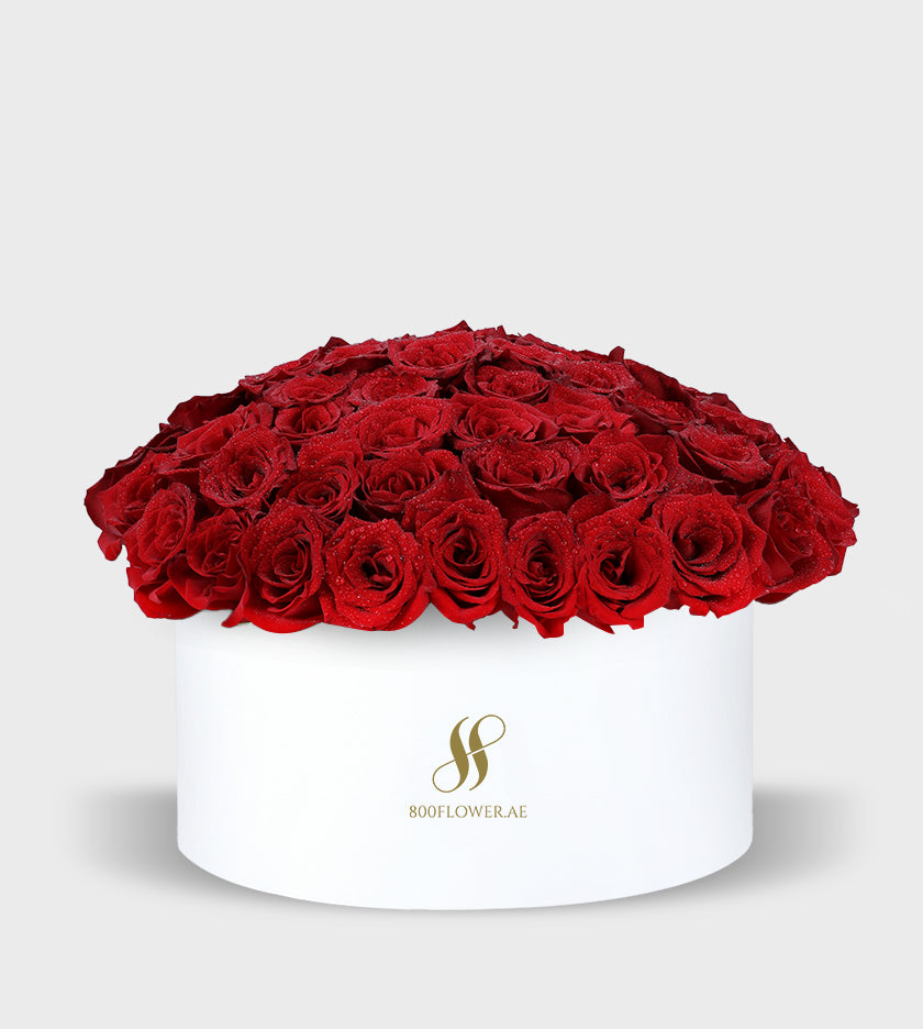 Red Roses Small Round Box with 70 vibrant red roses, radiating passion and serving as a heartfelt declaration of love and desire.