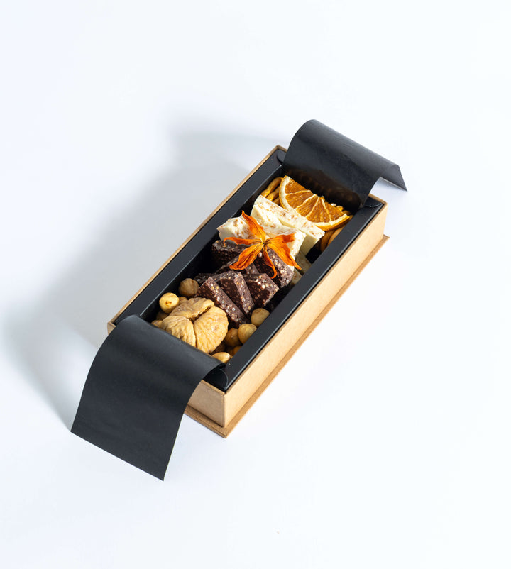 “Me Platter” with rich chocolates, figs, hazelnuts, and pretzels — balanced sweet and savory flavors.