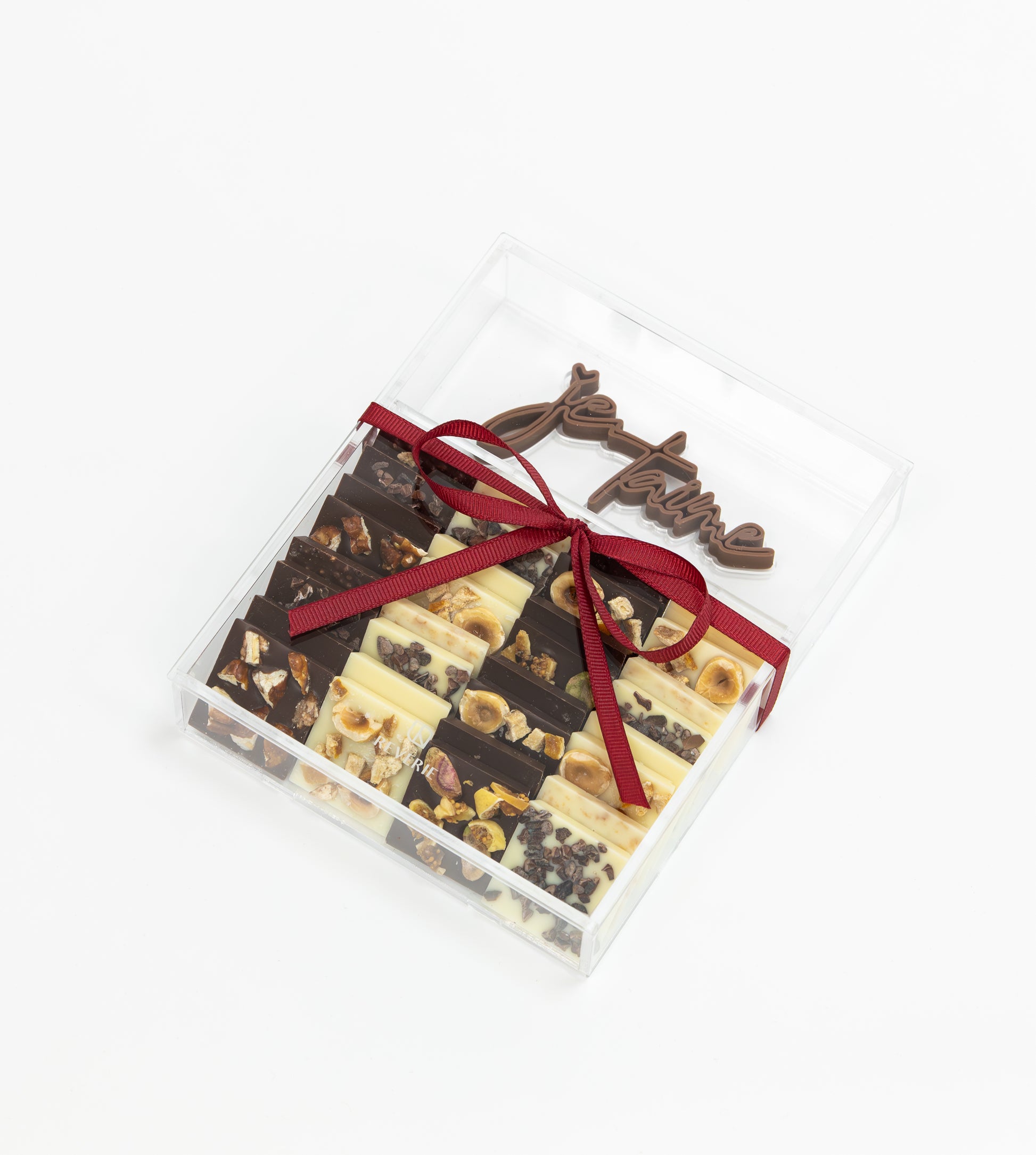 a romantic mix of dark, milk & white chocolates topped with nuts and cocoa nibs, beautifully wrapped.