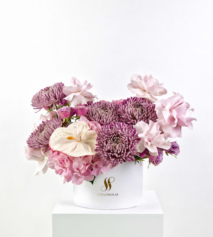 Bouquet of lilac chrysanthemums, pink roses, hydrangeas, and creamy anthurium.