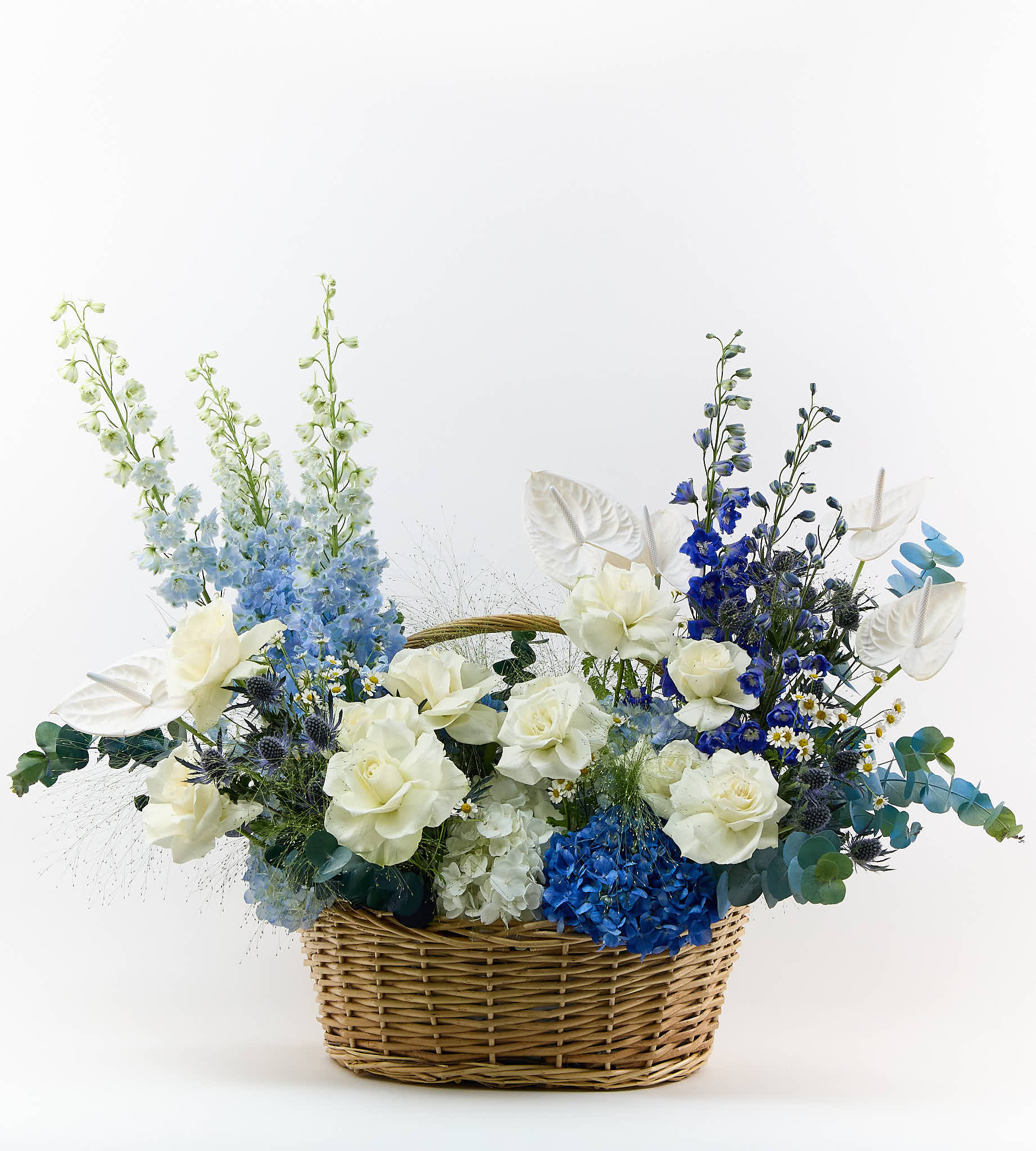 Bouquet with ocean blue and soft white flowers, calm and elegant arrangement.