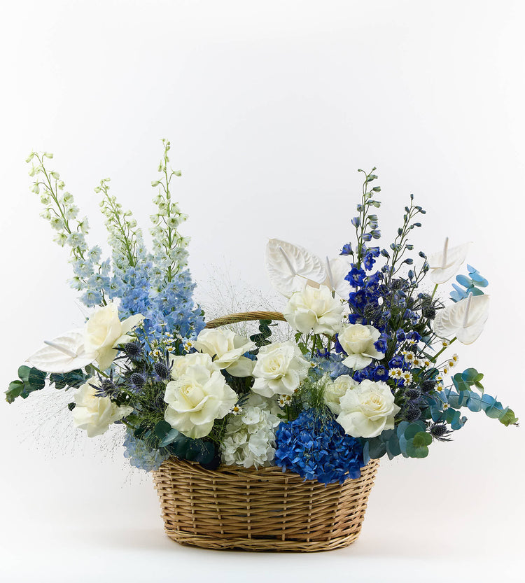 Bouquet with ocean blue and soft white flowers, calm and elegant arrangement.