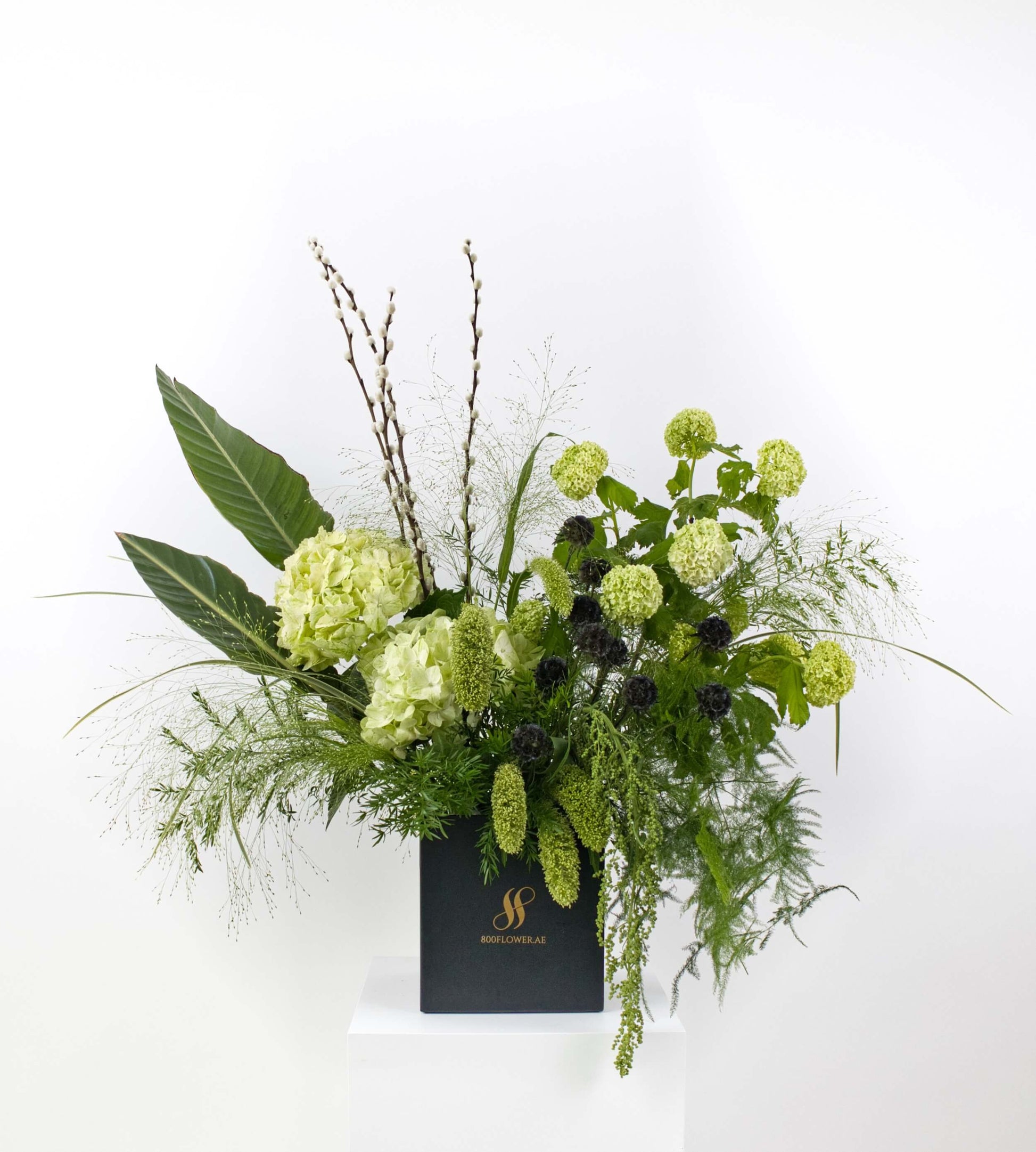 Bouquet with textured green foliage and earthy tones.