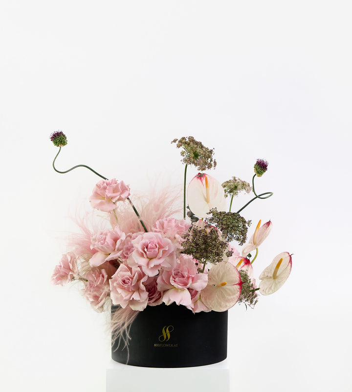 Wild Rosé bouquet with soft pink roses, sculptural anthuriums, and feathery textures.