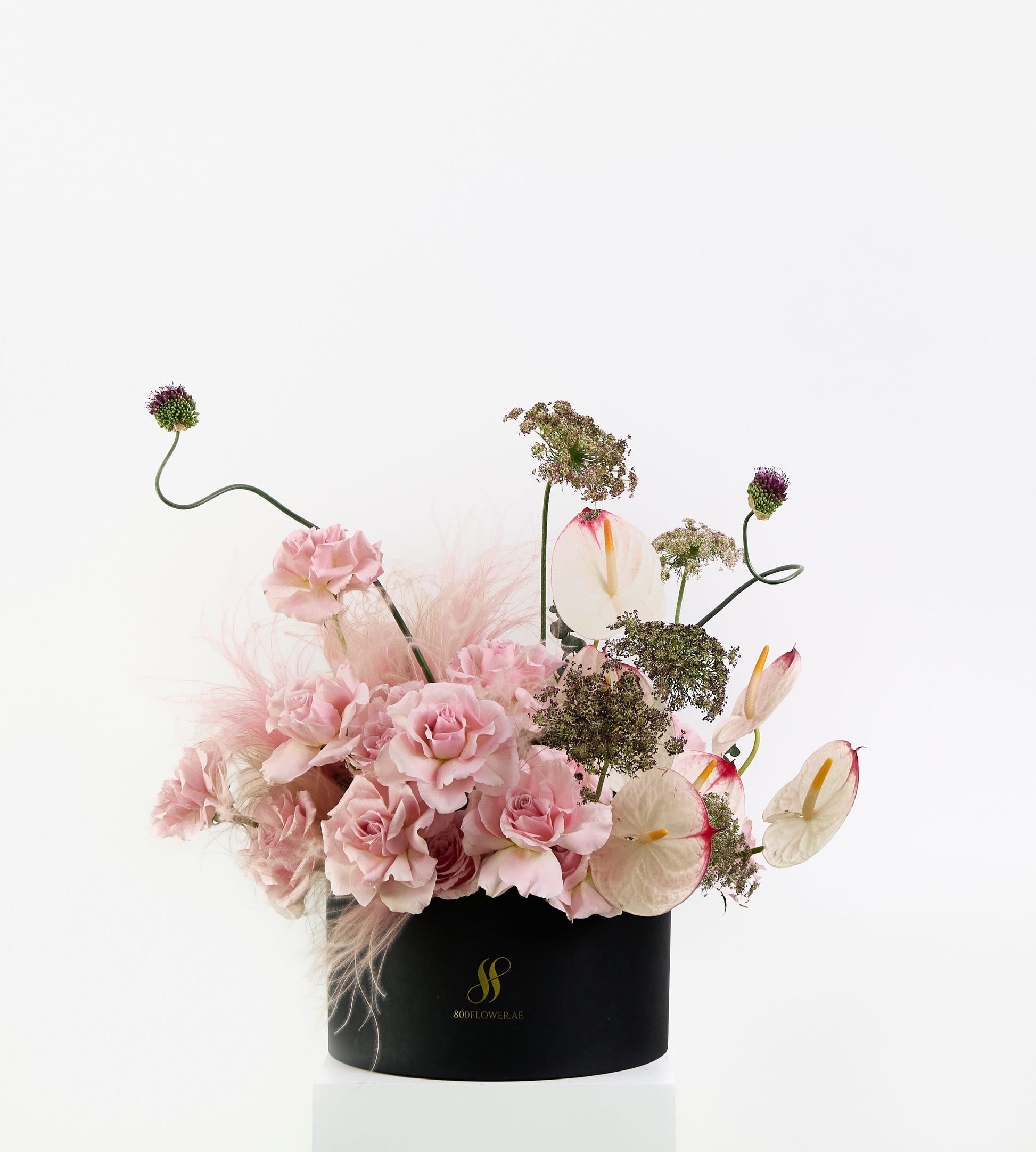 Wild Rosé bouquet with soft pink roses, sculptural anthuriums, and feathery textures.