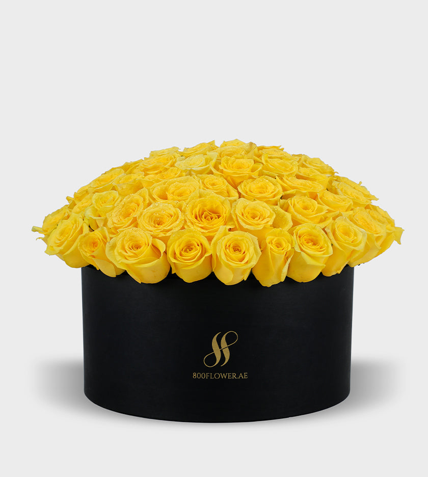 Yellow Roses Small Round Box with 70 radiant yellow roses, symbolizing joy, warmth, happiness, and friendship.